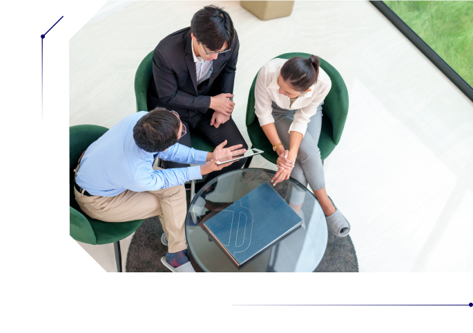 Two people listening closely to a man presenting something in his tablet